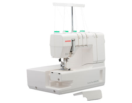 Machine à recouvrement Janome CoverPro 2000CPX vue en angle, avec le compartiment ouvert, montrant son design ergonomique et son espace de travail optimisé.